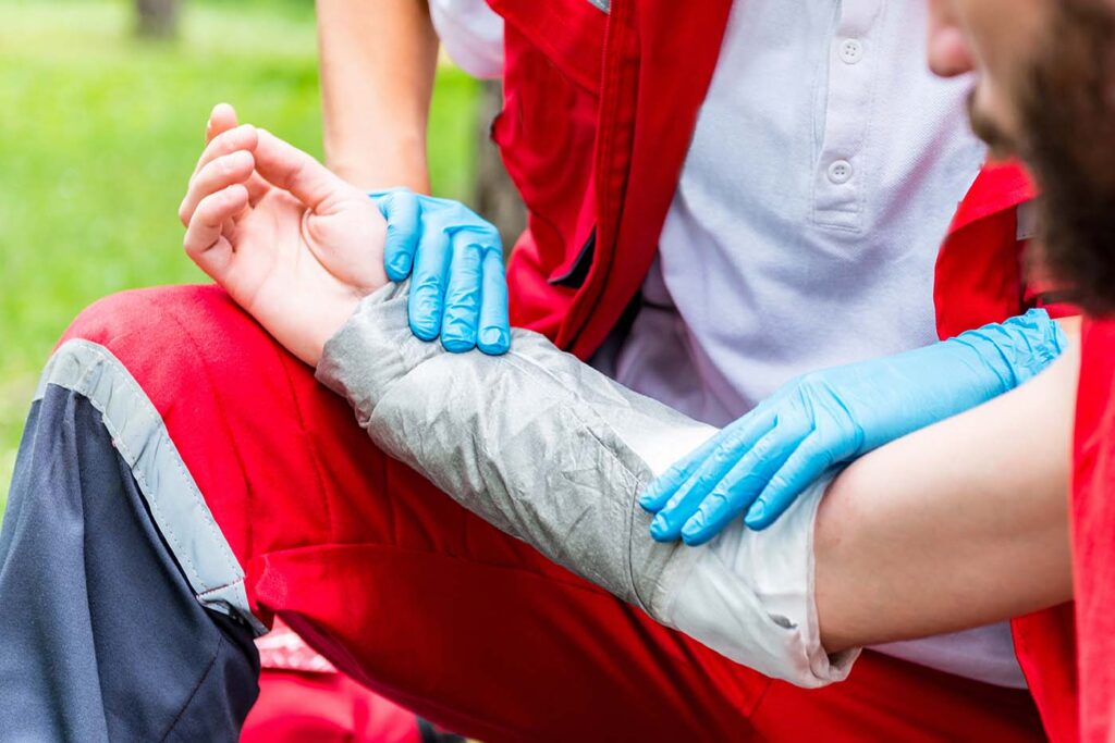 Clingfilm vs Traditional Burn Dressings Picture depicts a paramedic applying a specialist burns dressing to an adult patient's arm